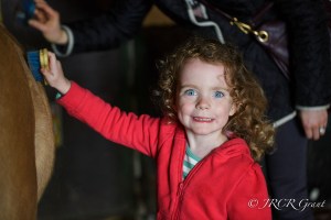Image of girl grinning by horse