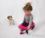 Girl plays with beagle puppy
