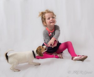 Girl and puppy playing with rope