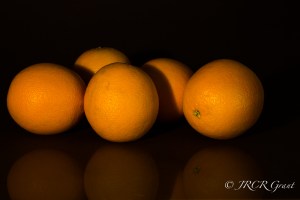 Oranges waiting in the shadows