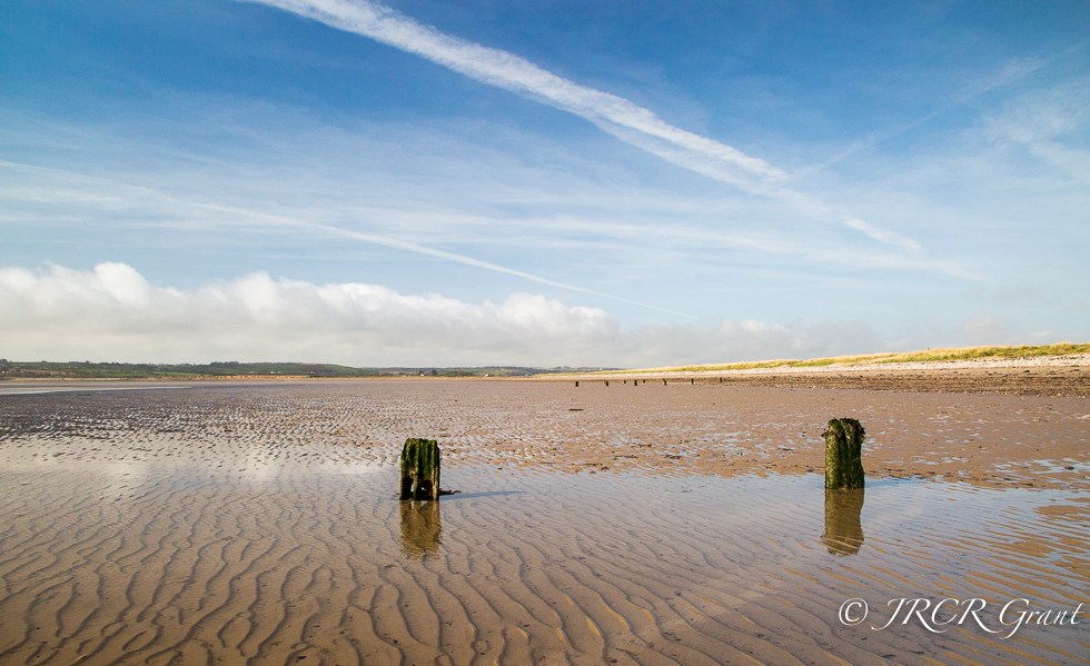 Beach with posts and ripples
