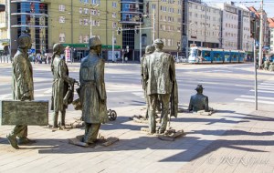 Statues of the Passage installation in Wroclaw disappear into the pavement