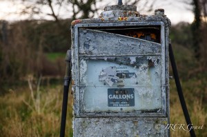The old dials of a discintegrating petrol pump are stuck on gallons, shillings and pence