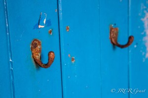 An old coat peg turns to rust on the wall of Whiddy Island School