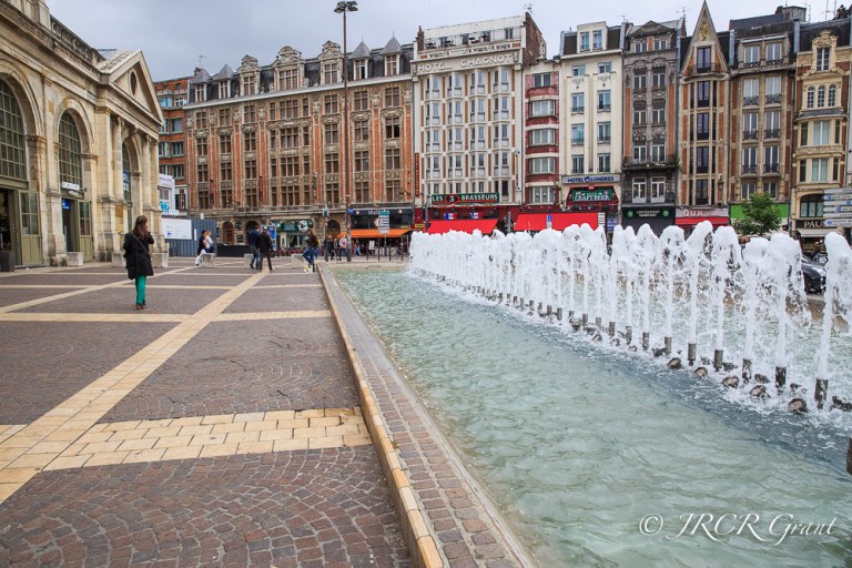 Colourful Place de Gare with fountains in the foreground, Lille