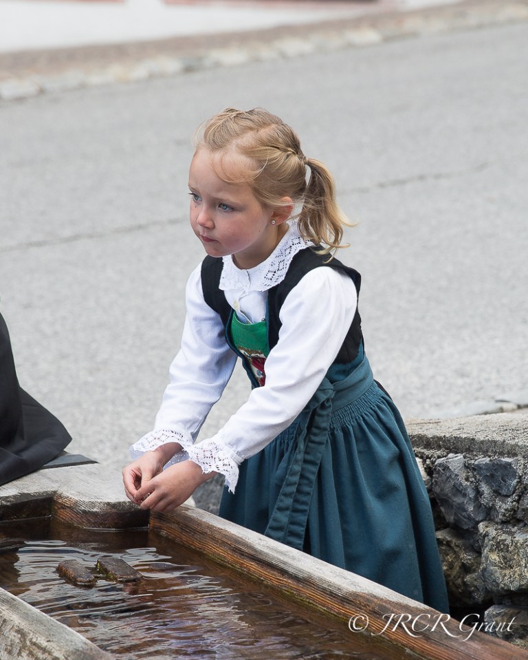 Young Austrian lady in traditional dress in the village of Alpbach, Tyrol, Austria