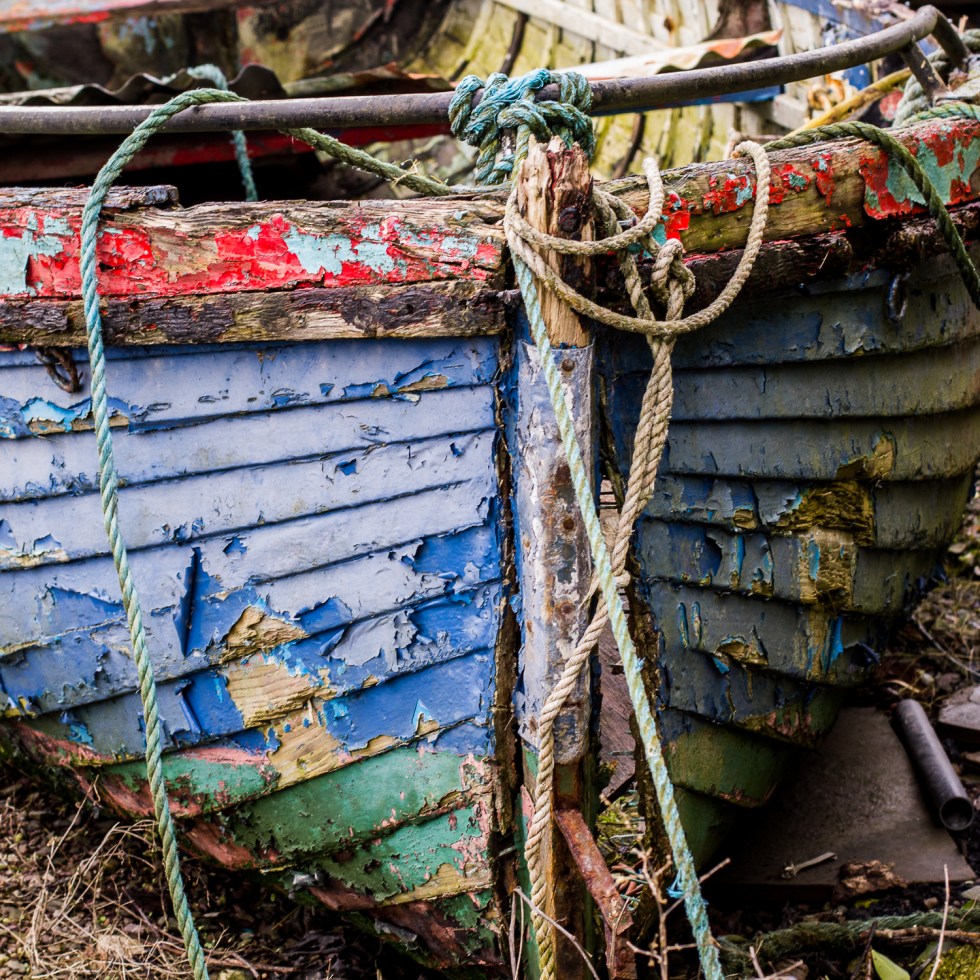 A boat lies on the banks, beaten by each and every wave
