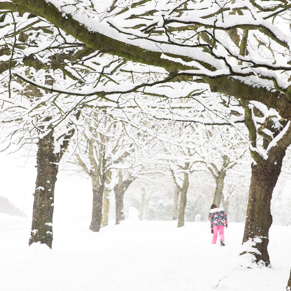 A girl in bright pink ski-pants makes her way through the deep snow in Cork City, Ireland