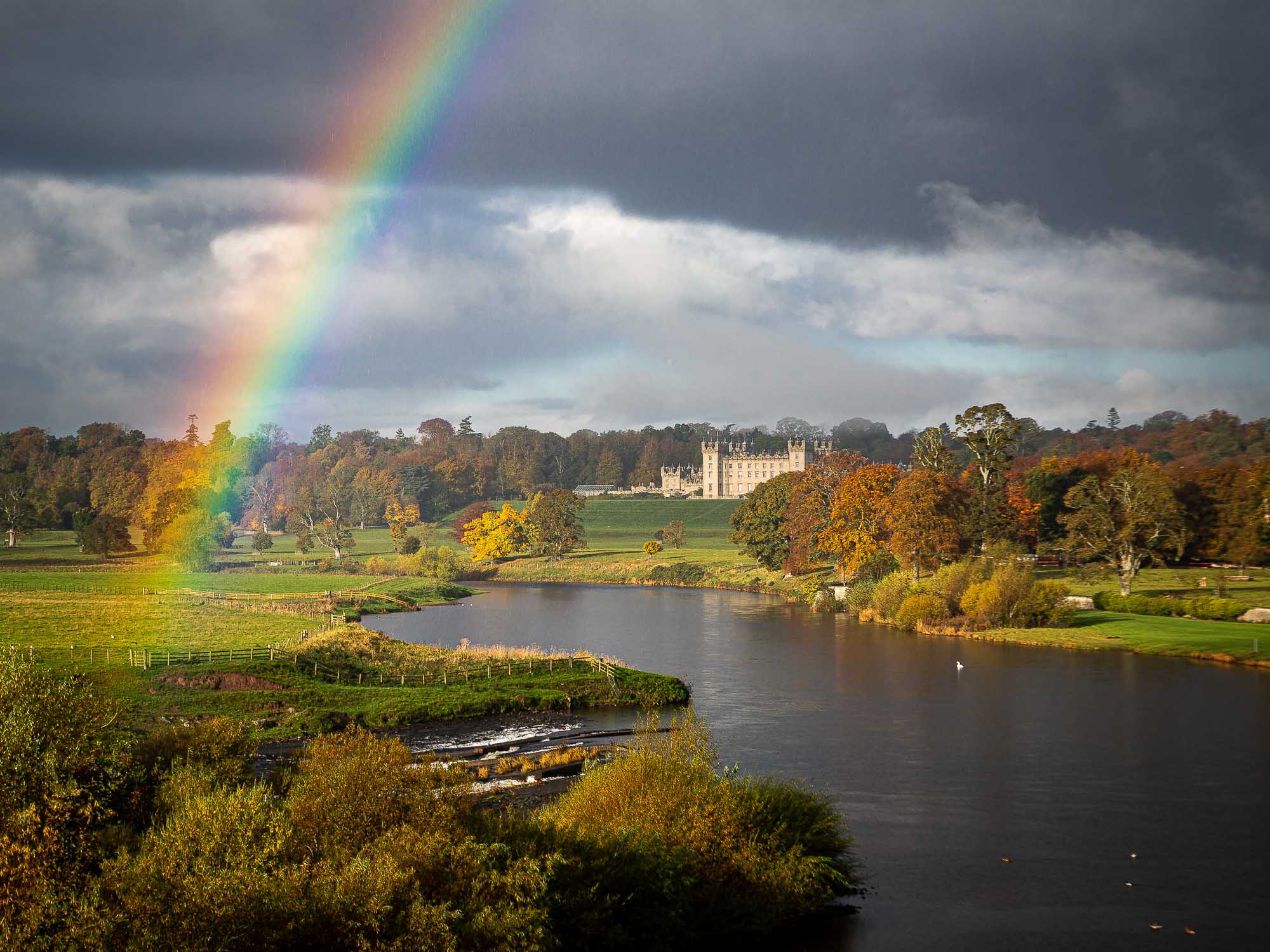 Floors Castle flanked by a rainbow