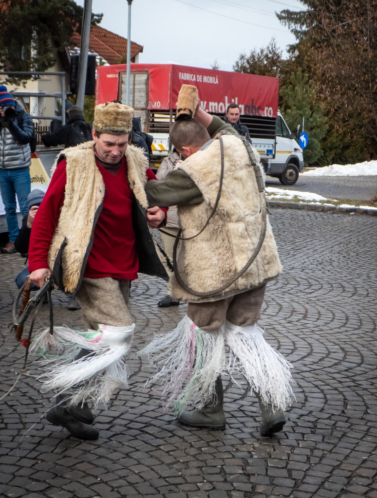 Two men dance in circles with joy